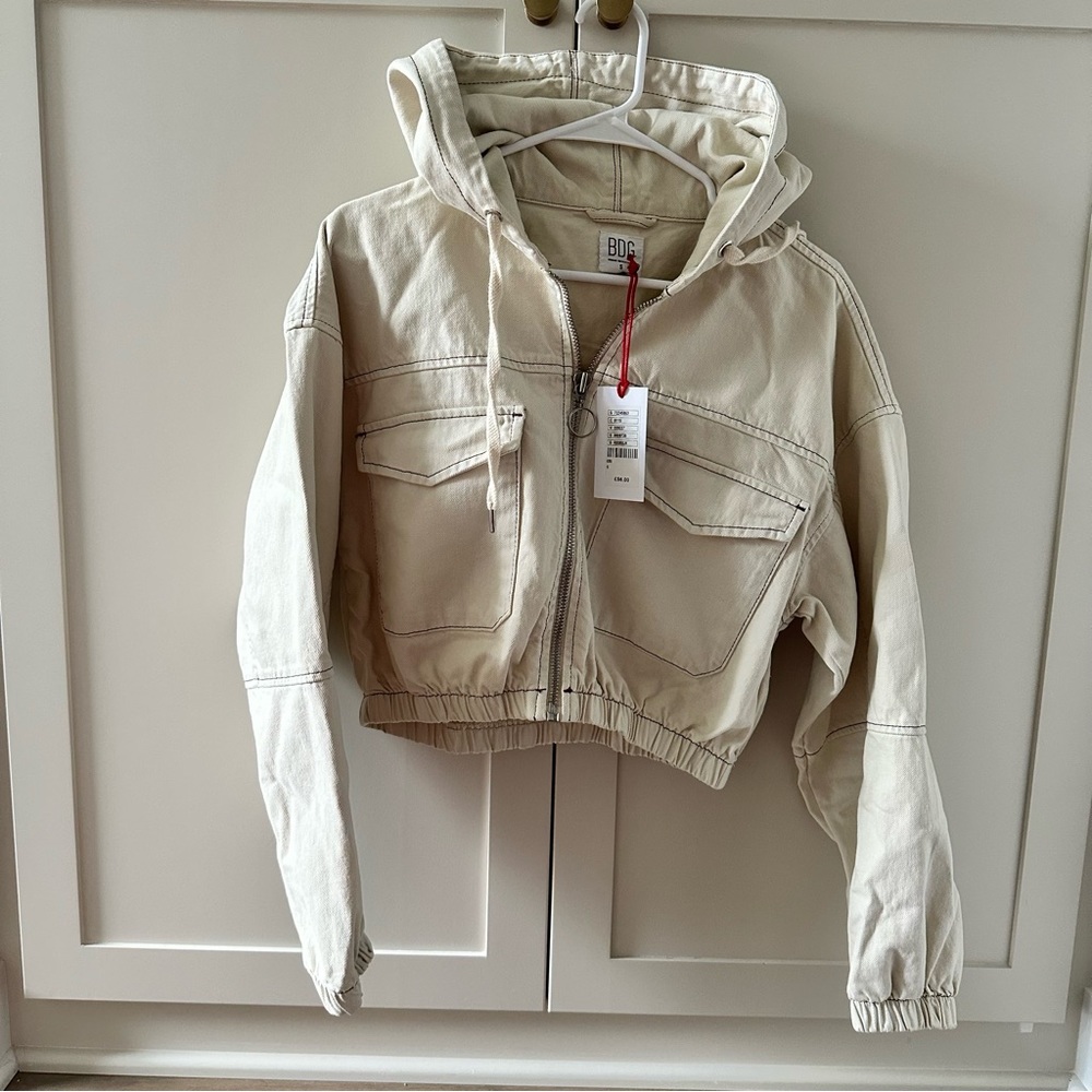 Cropped cream colored denim jacket.